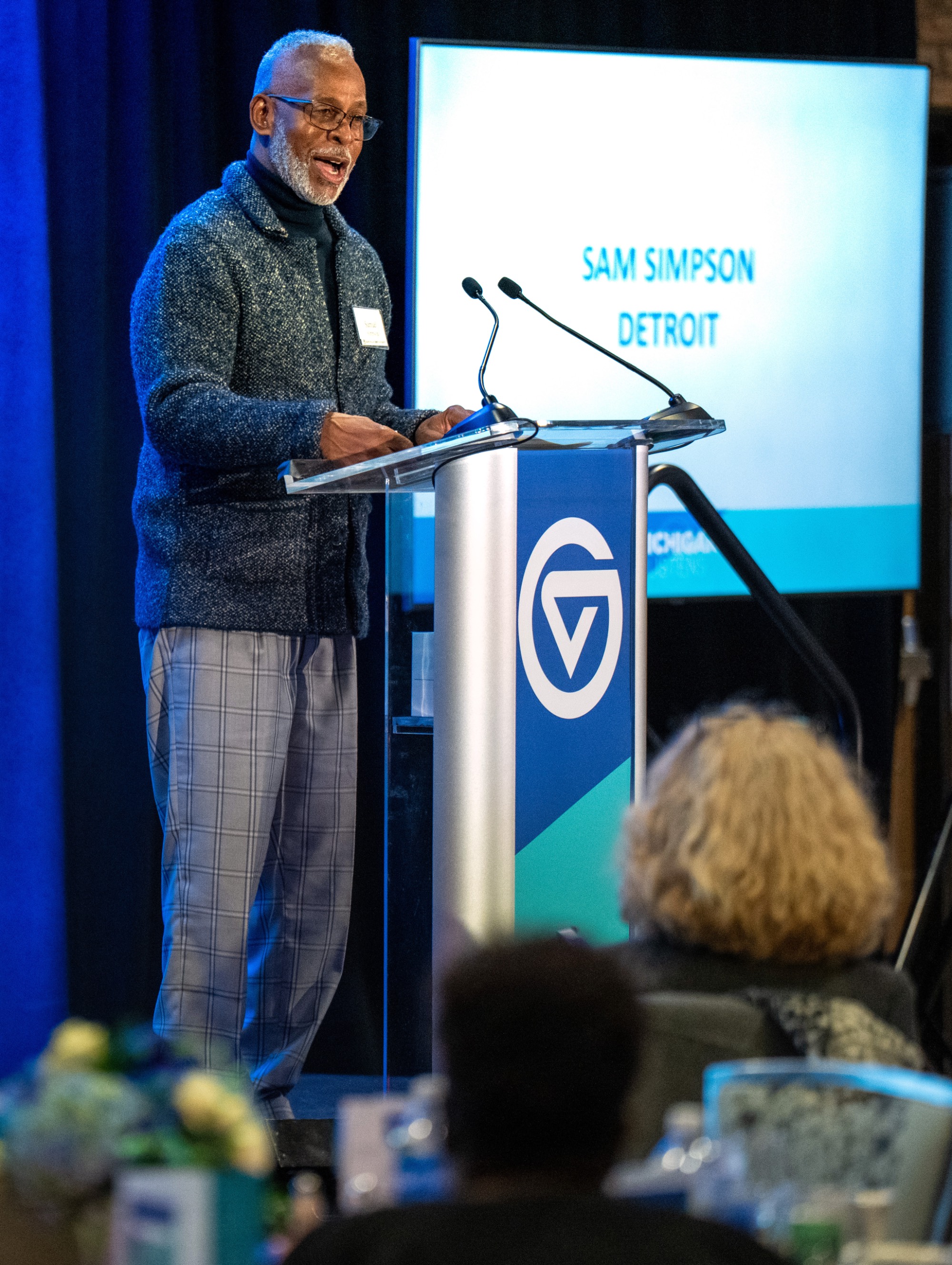 A male speaker at the podium